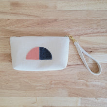 Load image into Gallery viewer, Simple clutch in a natural unbleached cotton. Texture in fabric has its natural nubby look. The Clutch has detachable wristlet strap made from same fabric as the clutch. It is also decorated with a fabric half sun, moon. 
