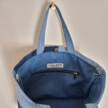 Load image into Gallery viewer, Open patchwork denim light weight tote showing gold zipper, triangle strap rings and magnetic closure.
