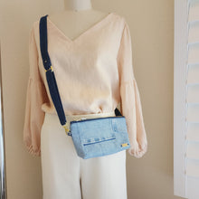 Load image into Gallery viewer, This photo shows the crossbody style with strap fully extended worn over the shoulder.
